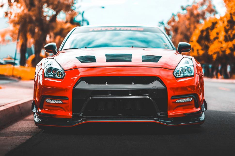 Free Image of Red Sports Car Parked on Side of Road 