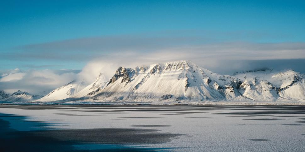 Free Image of Majestic Snow-Covered Mountain Under Blue Sky 