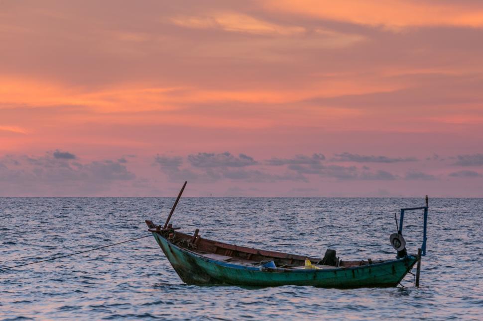 Free Image of Boat Sailing in Ocean at Sunset 