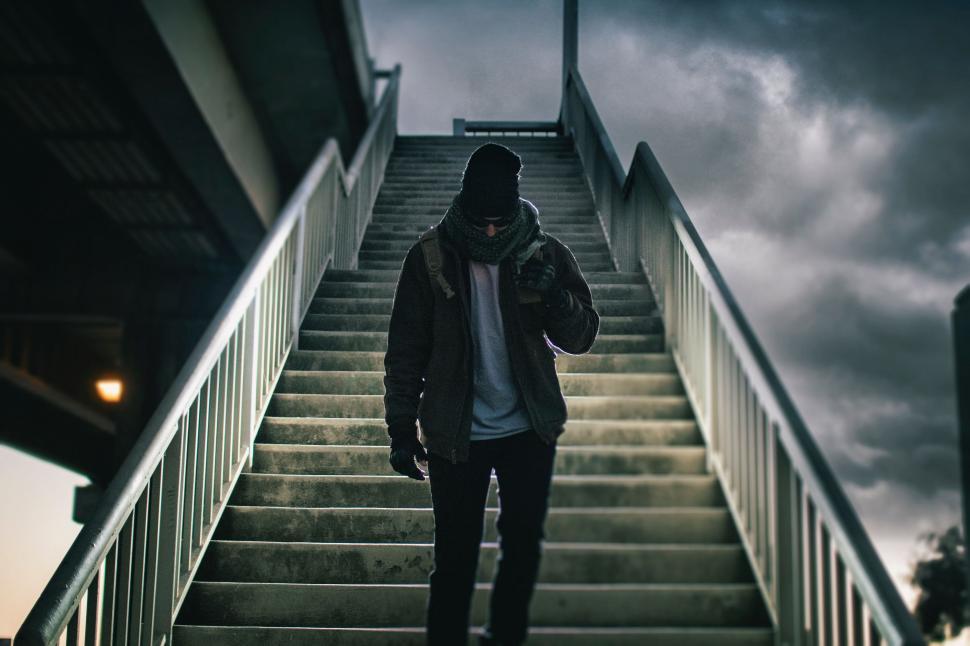 Free Image of Man Walking Down a Flight of Stairs 