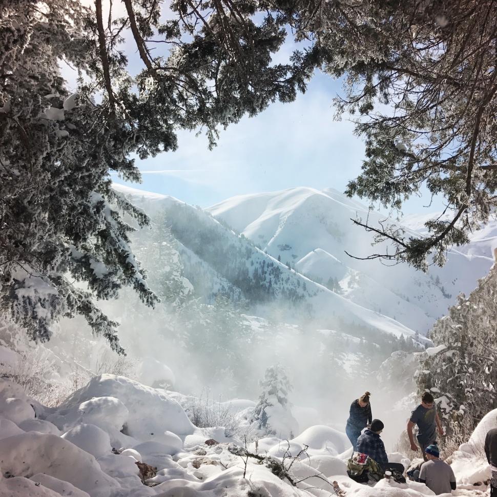 Free Image of Group of People Standing on Top of Snow Covered Slope 