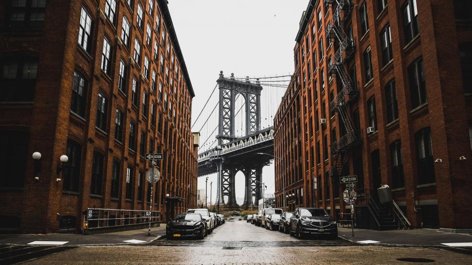 Free Image of City Street With Bridge in Background 