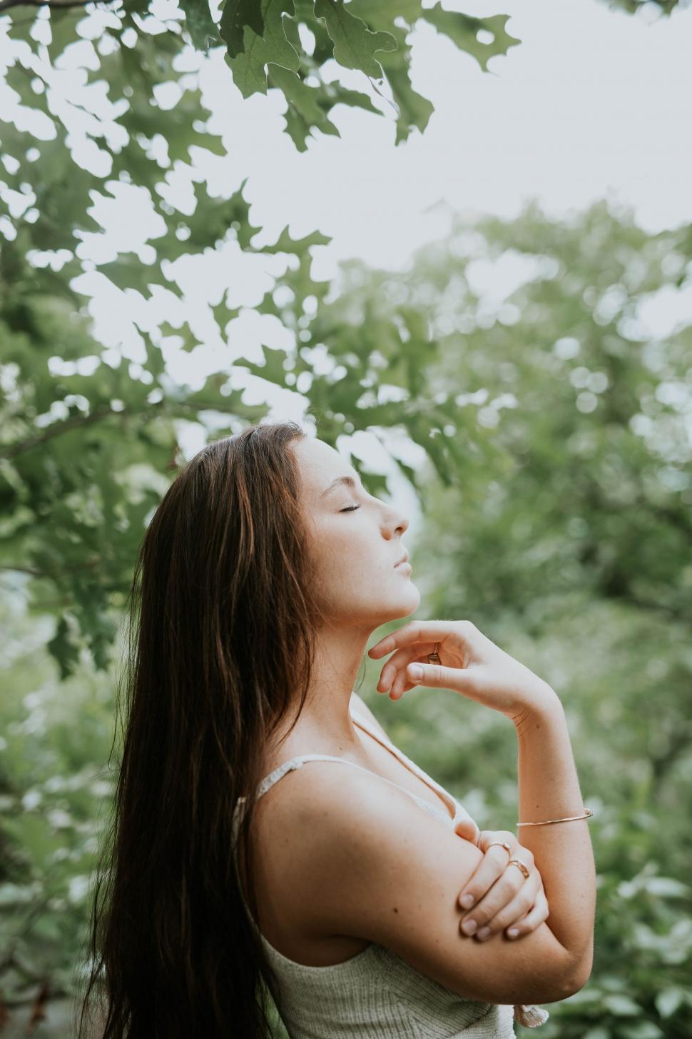 Free Image of Woman Standing in Front of Tree 