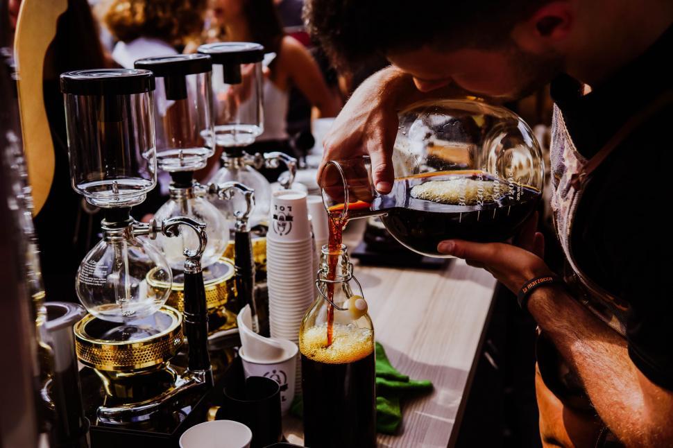 Free Image of Man Pouring Glass of Wine at Bar 
