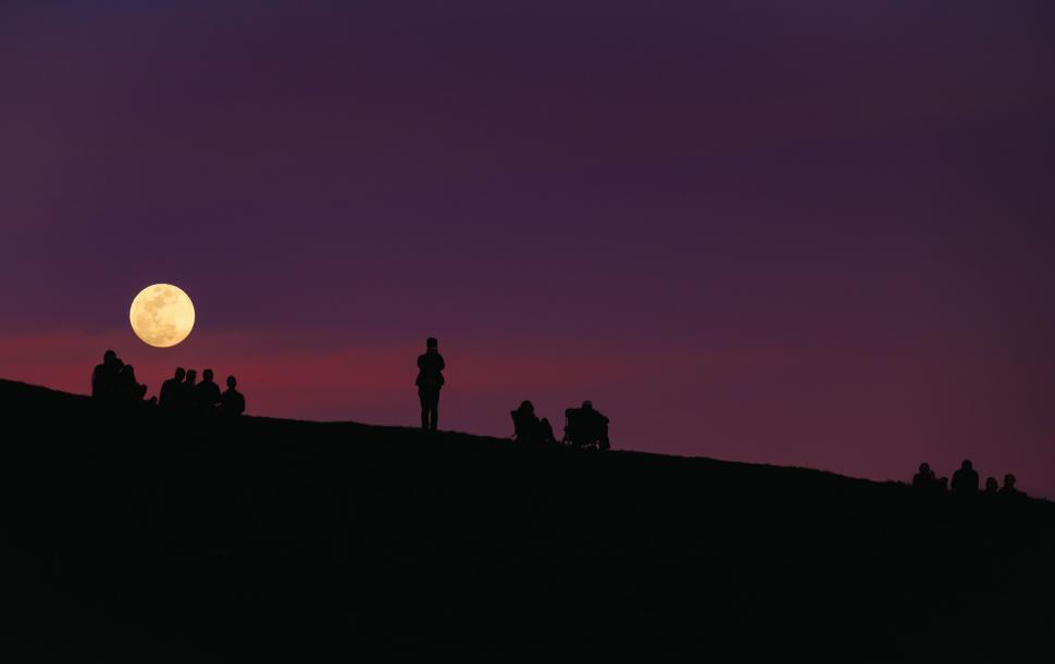 Free Image of Group of People Standing on Top of a Hill 