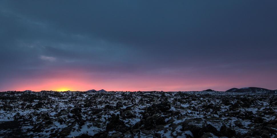 Free Image of Sun Setting Over Rocky Landscape 