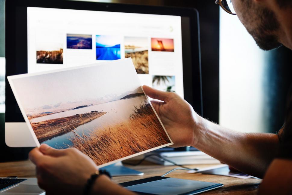 Free Image of Man Looking at Picture on Computer Screen 