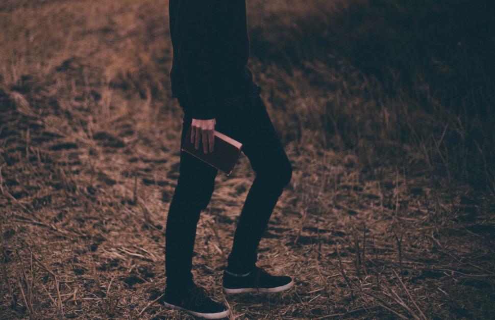 Free Image of Person Standing in Field With Cell Phone 