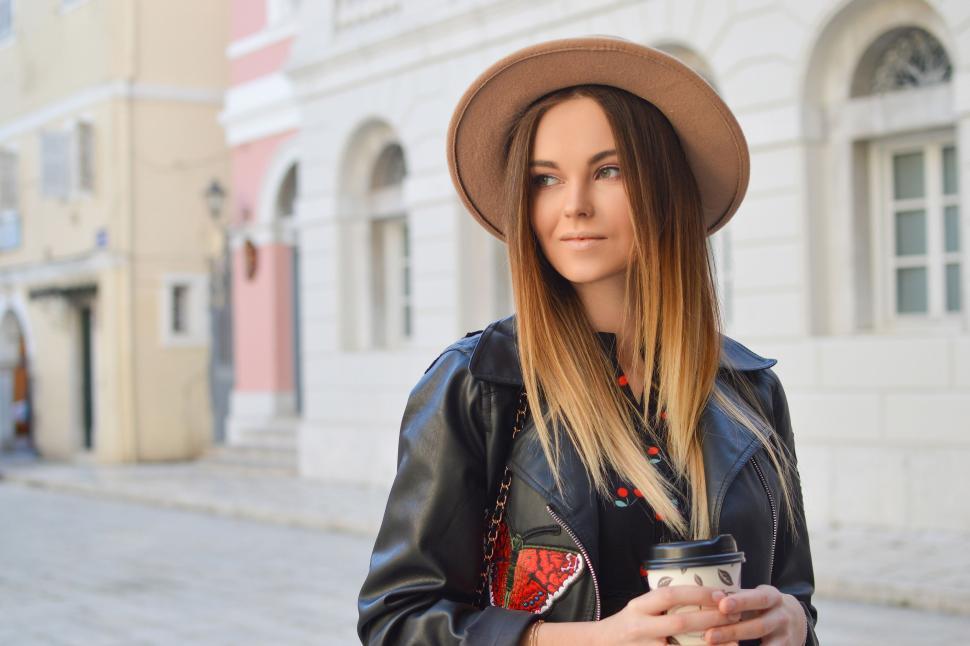 Free Image of Woman Wearing Hat Holding Cup of Coffee 