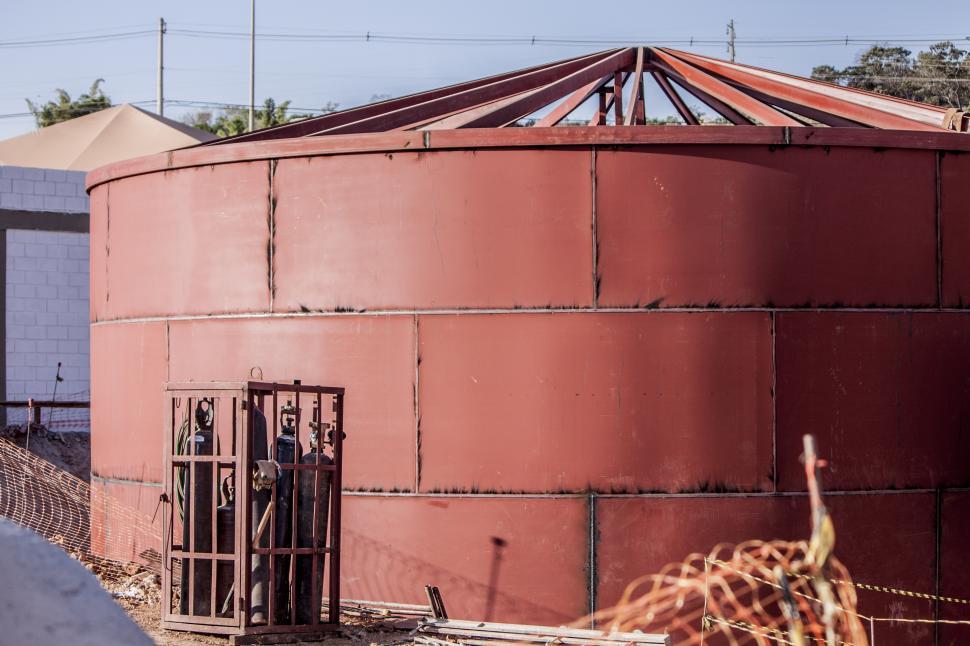 Free Image of Giraffe Standing by Tall Red Building 
