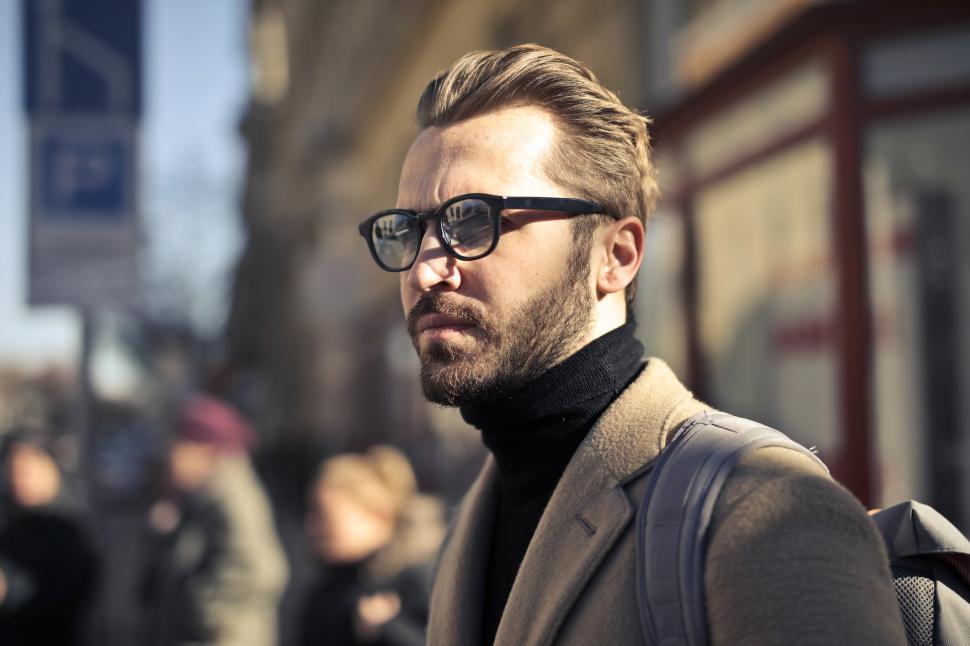 Free Image of Selective Focus on the face of young bearded male backpacker wit 