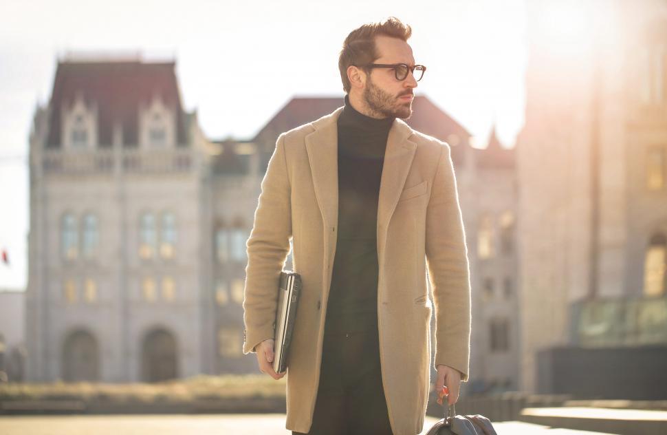 Free Image of Young adult bearded male with eyeglasses,walks on street with la 