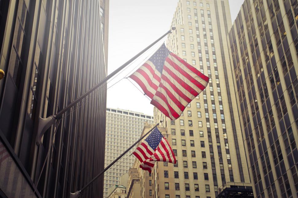 Two Flags of USA Under White Clouds at Daytime