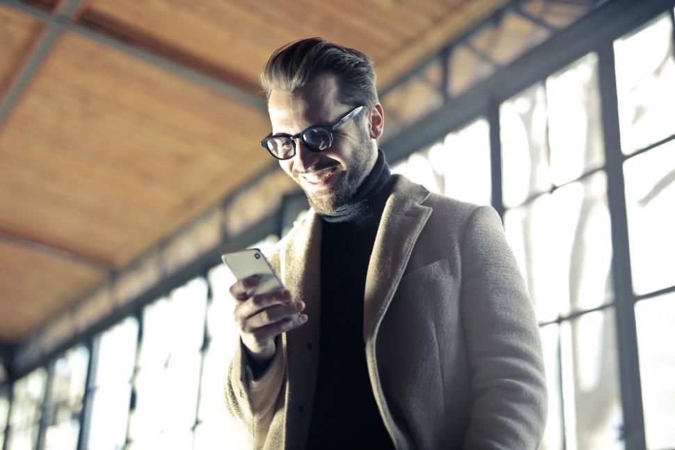 Free Image of Young Adult Man using a cellphone 