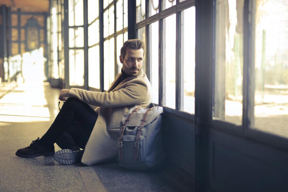 Free Stock Photo of Young Man sitting near window