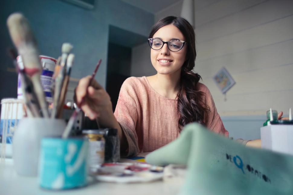 Free Image of A young woman with glasses picking colour with the blush 