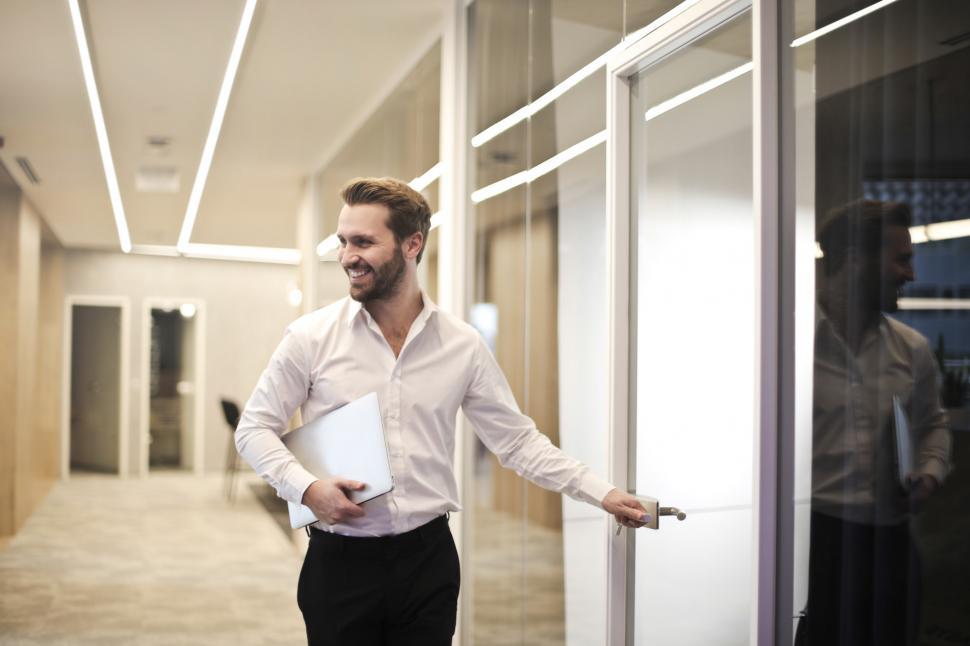 Free Image of A young bearded caucasian man entering a glass cabin 