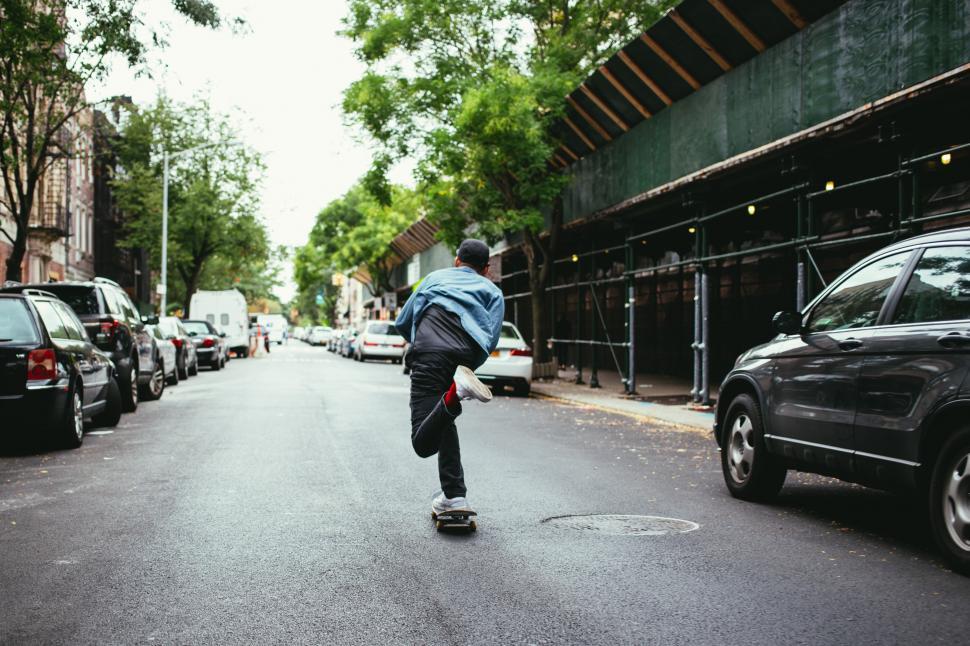 A young caucasian skateboarder in the street