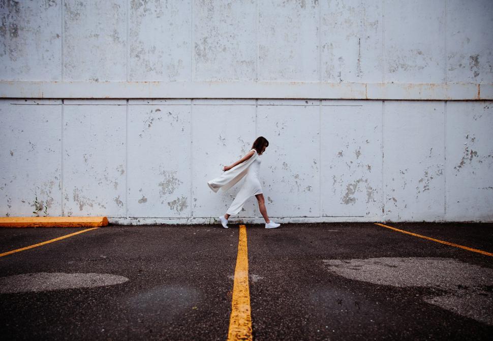 Free Image of A young Caucasian woman walking on the street 