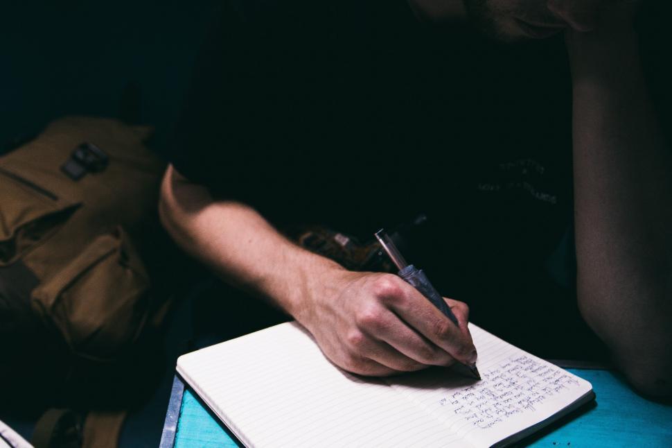 Free Stock Photo of A journalist writing on notepad Download Free