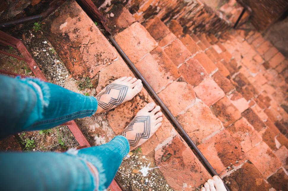 Free Image of Tattooed female feet on steep staircase 
