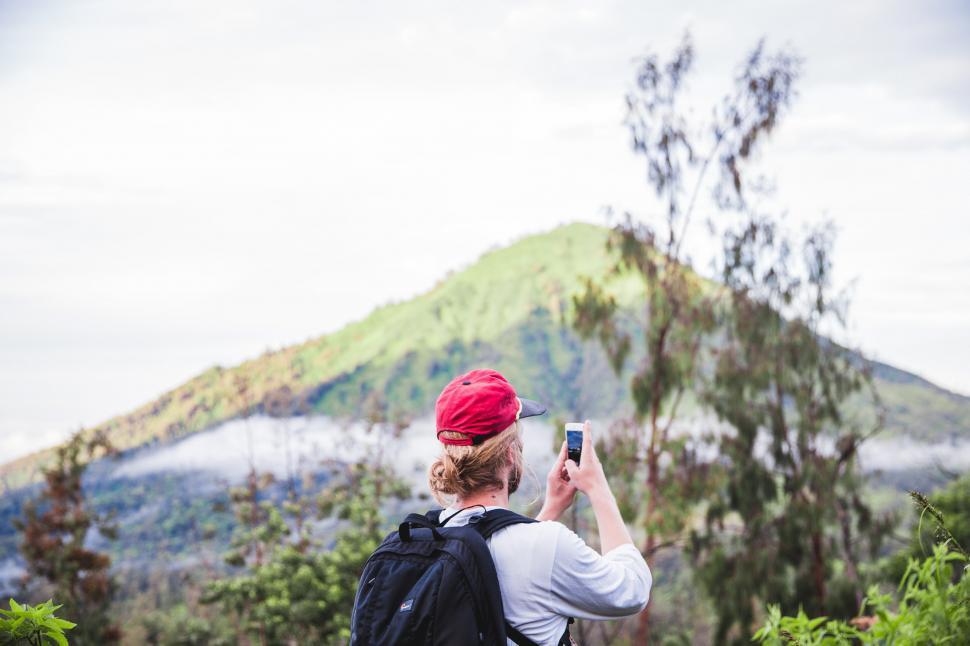 Free Image of A hiker clicking picture from his mobile phone 