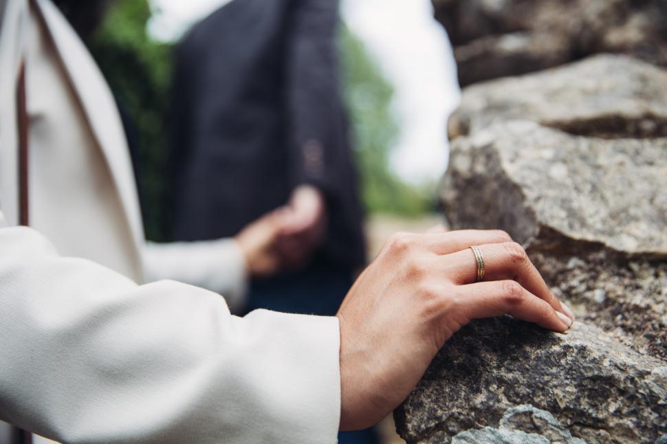 Free Image of A young Caucasian couple holding each other s hands 