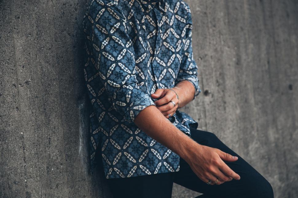 Free Image of A young caucasian man wearing patterned shirt posing outdoors 