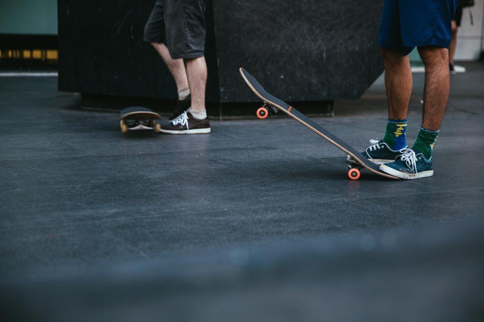 Free Image of Skateboarders stepping on skateboard 