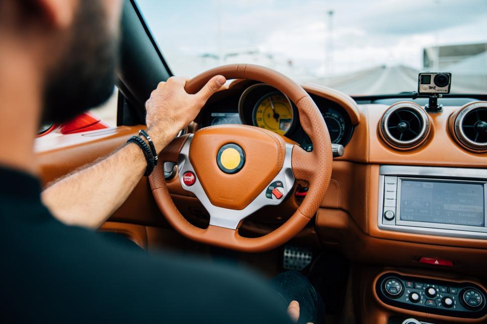 Free Image of A car s interior with a bearded young man on driver s seat 