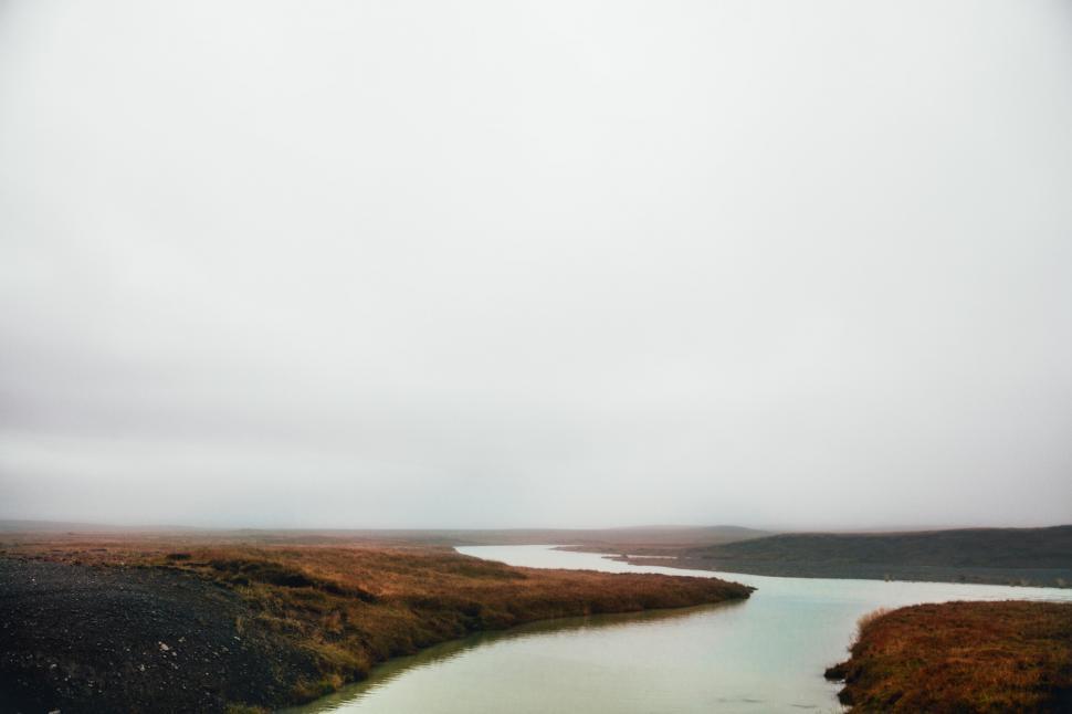 Free Image of Panoramic view of gray cloudy sky over the fall field 