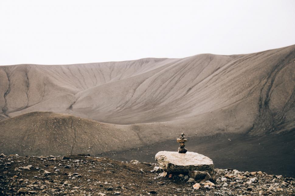 Free Image of Stacked stones rock art in the desert hills 