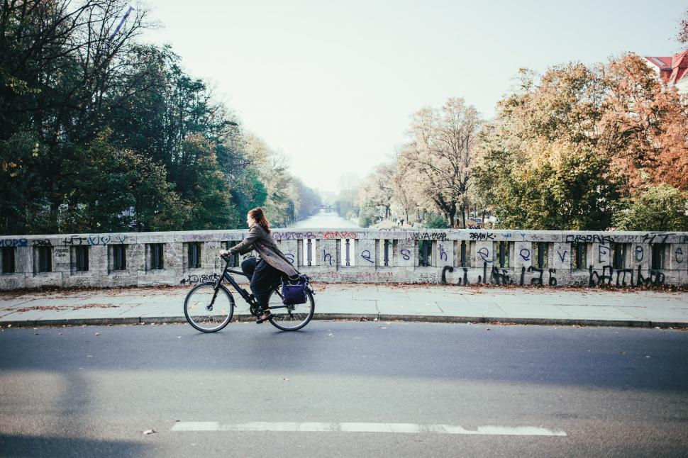 Free Image of Cyclist on a river bridge in a winter day 