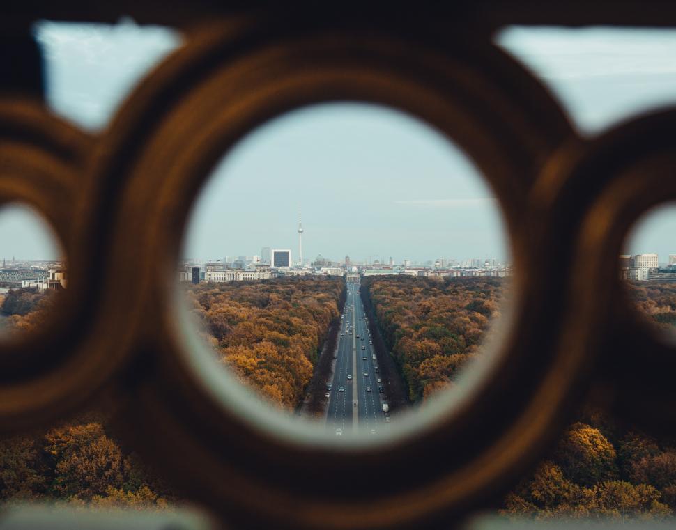 Free Image of A view of fall forest highway through high architecture 