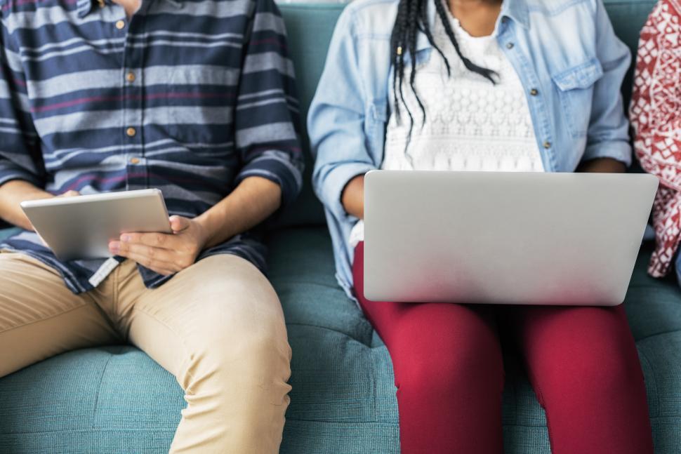 Free Image of A woman working on her laptop and a man looking at his tablet PC 