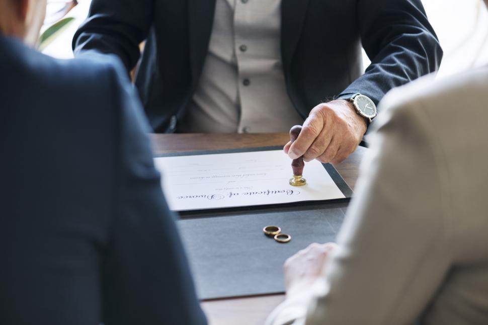 Free Image of Certificate of divorce being attested by a judge in front on for 