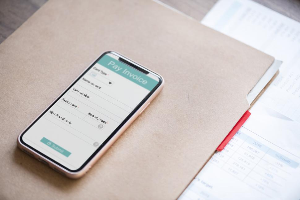 Free Image of Close up of a mobile phone on a file folders 