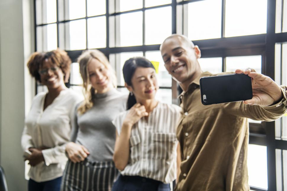 Free Image of Multiethnicity people taking a group photo with mobile phone 