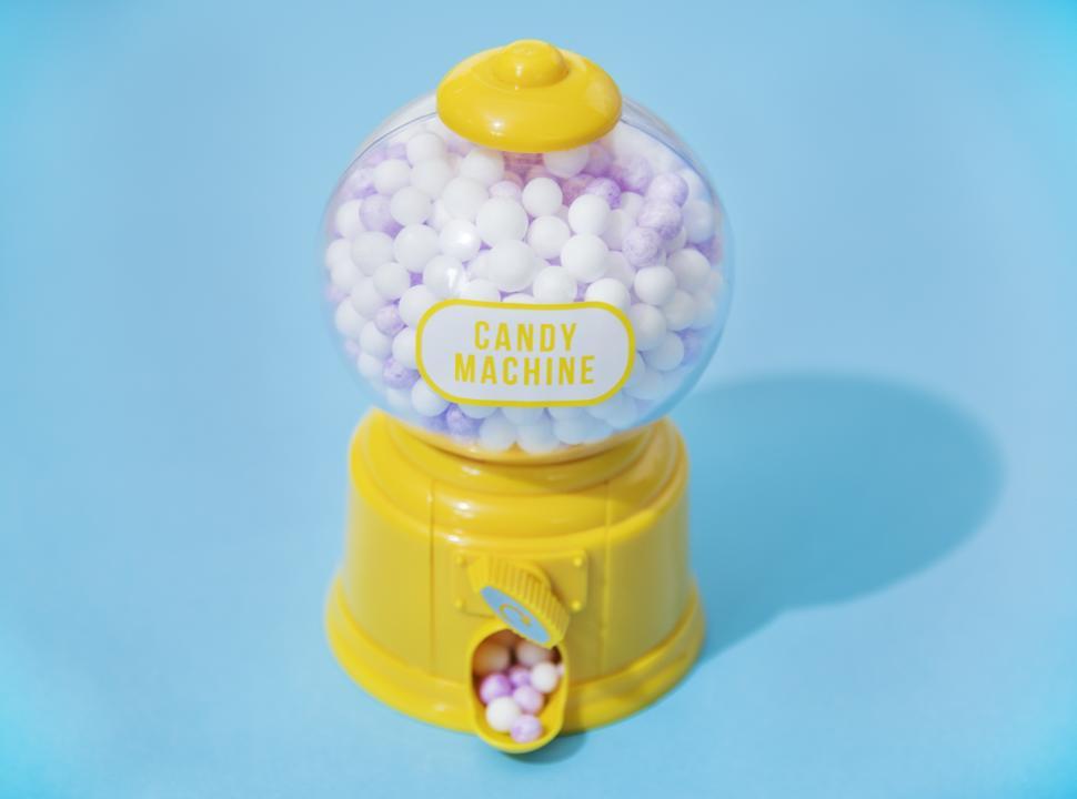 A retro chewing gum machine filled with gumballs