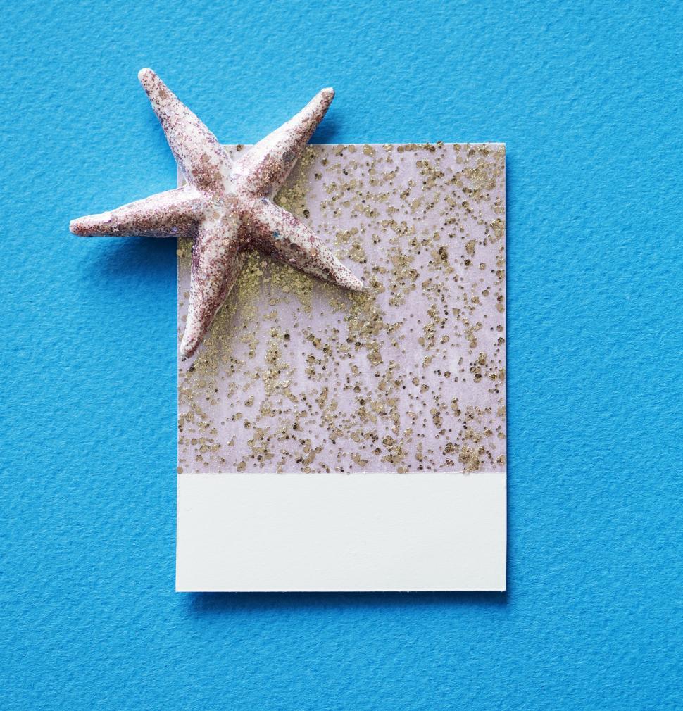 Free Image of Flay lay of a miniature toy fly on a glittery spaced cardboard frame 