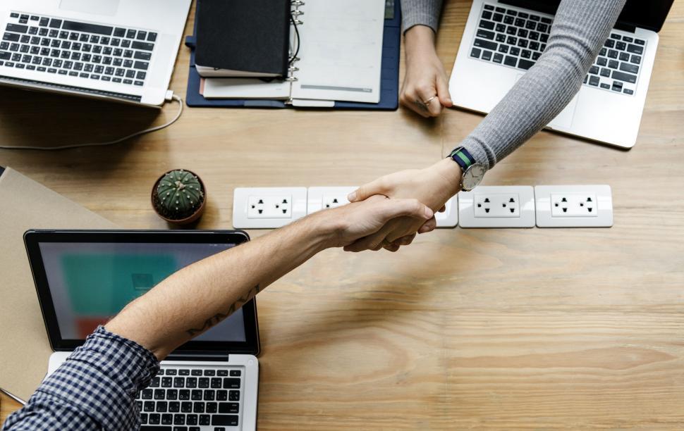Free Image of Handshake between the laptops 