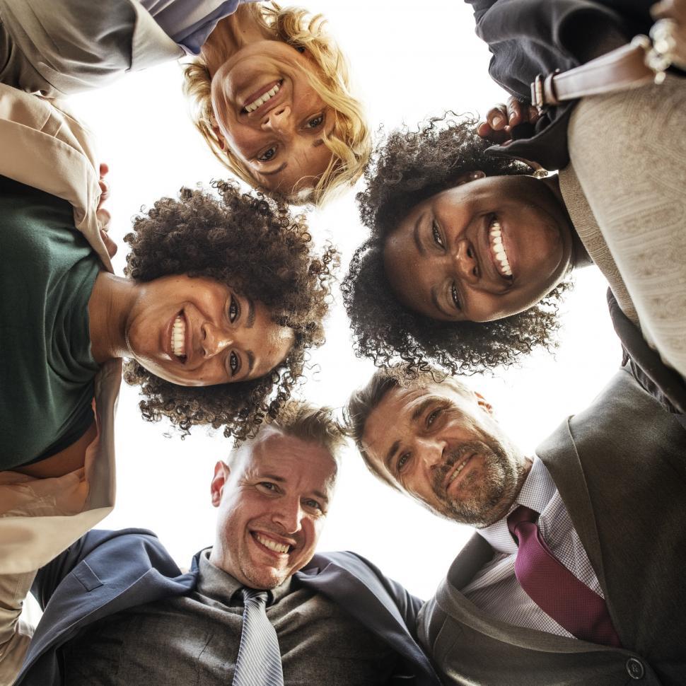 Free Image of Square low angle view looking up at a team huddle 