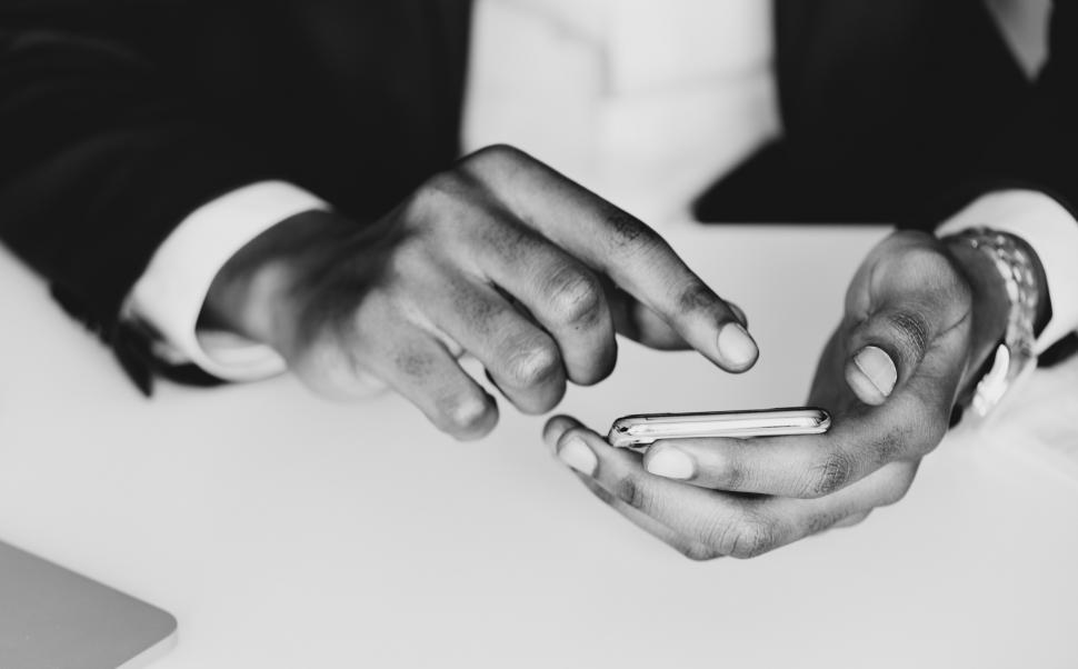 Free Image of Close up of hands touching a mobile phone screen 