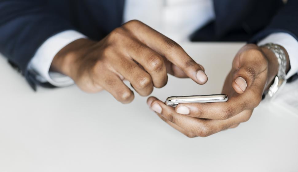 Free Image of Close up of hands working with phone screen 