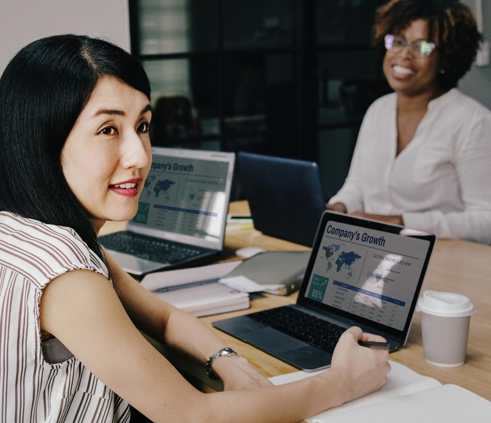 Free Image of Two colleagues in the office looking toward camera 