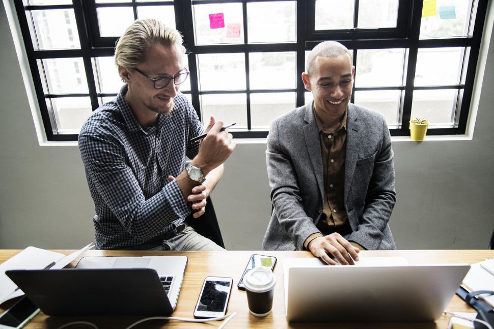 Free Image of Two male colleagues in the office with computers 