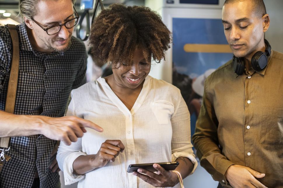 Free Image of Commuters looking at mobile phone s screen in the train 