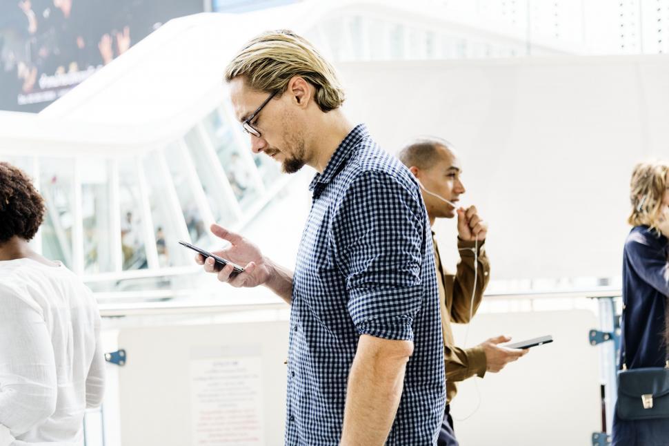Free Image of A bearded Caucasian man looks at his mobile phone 