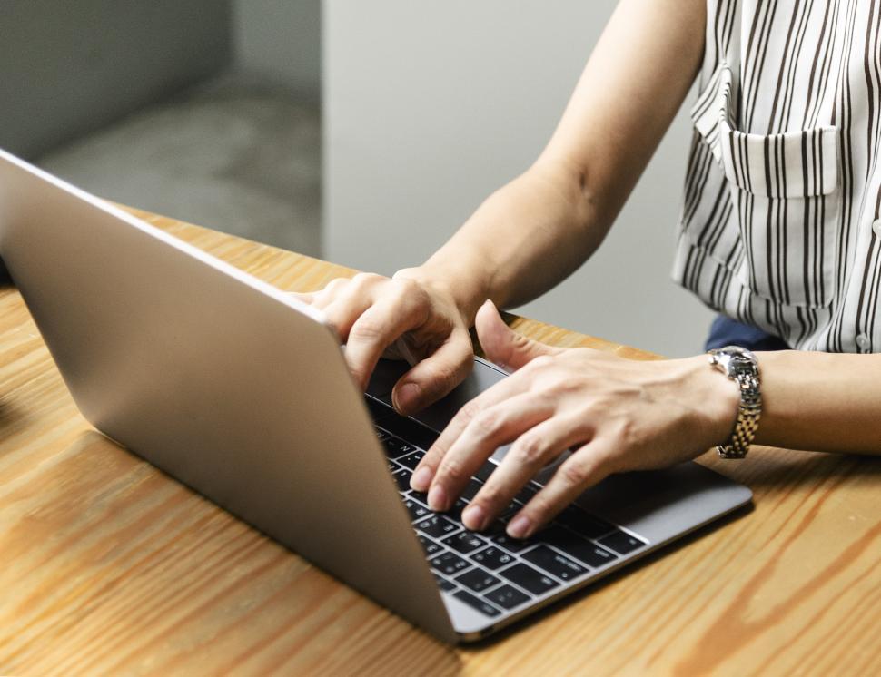 Free Image of Close up of  hands typing on the laptop 