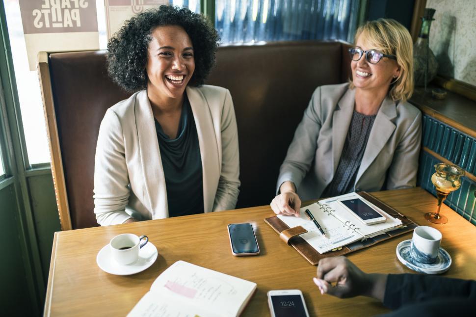 Free Image of A women sitting at a cafe 